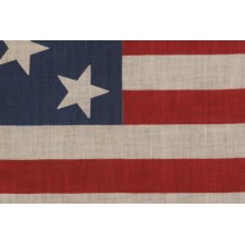 ANTIQUE 13 STAR PARADE FLAG WITH A 3-2-3-2-3 CONFIGURATION, MADE CIRCA 1876-1898, EXTREMELY SCARCE AND UNUSUALLY LARGE AMONG ITS COUNTERPARTS OF THE 19TH CENTURY
