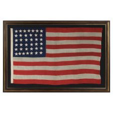 ANTIQUE 38 STAR FLAG WITH HAND-SEWN STARS, IN A SMALL SCALE AMONG PIECED-AND-SEWN EXAMPLES, WITH WONDERFUL FOLK QUALITIES, COLORADO STATEHOOD, 1876-1889