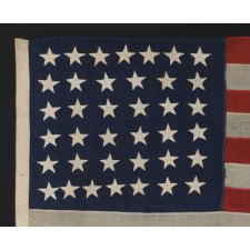ANTIQUE 38 STAR FLAG WITH HAND-SEWN STARS, IN A SMALL SCALE AMONG PIECED-AND-SEWN EXAMPLES, WITH WONDERFUL FOLK QUALITIES, COLORADO STATEHOOD, 1876-1889