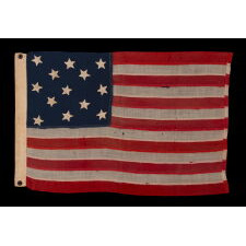 ANTIQUE AMERICAN FLAG WITH 13 HAND-SEWN STARS IN A 3-2-3-2-3 CONFIGURATION, MADE IN THE ERA OF THE 1876 CENTENNIAL OF AMERICAN INDEPENDENCE, IN AN EXTRAORDINARY AND VERY DESIRABLE SIZE AMONG ITS COUNTERPARTS
