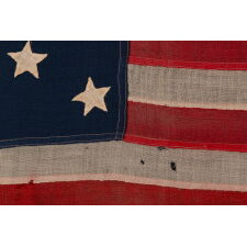 ANTIQUE AMERICAN FLAG WITH 13 HAND-SEWN STARS IN A 3-2-3-2-3 CONFIGURATION, MADE IN THE ERA OF THE 1876 CENTENNIAL OF AMERICAN INDEPENDENCE, IN AN EXTRAORDINARY AND VERY DESIRABLE SIZE AMONG ITS COUNTERPARTS
