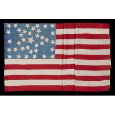 ANTIQUE AMERICAN FLAG WITH 37 STARS ON A CORNFLOWER BLUE CANTON, ARRANGED IN A UNIQUE “GREAT STAR” OR “GREAT LUMINARY” CONFIGURATION, INCORPORATED INTO A RECTANGULAR MEDALLION; A HOMEMADE EXAMPLE, MADE DURING THE ERA OF AMERICAN RECONSTRUCTION; REFLECTS NEBRASKA STATEHOOD, 1867-1876