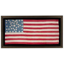 ANTIQUE AMERICAN FLAG WITH 37 STARS ON A CORNFLOWER BLUE CANTON, ARRANGED IN A UNIQUE “GREAT STAR” OR “GREAT LUMINARY” CONFIGURATION, INCORPORATED INTO A RECTANGULAR MEDALLION; A HOMEMADE EXAMPLE, MADE DURING THE ERA OF AMERICAN RECONSTRUCTION; REFLECTS NEBRASKA STATEHOOD, 1867-1876