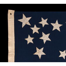 EXCEPTIONAL ANTIQUE AMERICAN FLAG WITH 38 GLAZED COTTON STARS, IN 3 DIFFERENT SIZES, ARRANGED IN A BEAUTIFULLY GRAPHIC, DOUBLE-WREATH STYLE MEDALLION, WITH TRIANGLES OF 4 STARS IN EACH CORNER, LIKELY MADE FOR THE 1876 CENTENNIAL, REFLECTS THE ERA WHEN COLORADO WAS THE MOST RECENT STATE TO JOIN THE UNION, 1876-1889