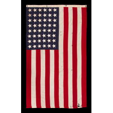 ANTIQUE AMERICAN FLAG WITH 48 STARS, A U.S. NAVY SMALL BOAT ENSIGN, MADE DURING WWII, IN DECEMBER OF 1943, AT MARE ISLAND, CALIFORNIA, HEADQUARTERS OF THE PACIFIC FLEET, SIGNED & DATED