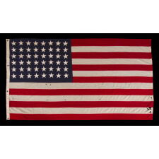 ANTIQUE AMERICAN FLAG WITH 48 STARS, A U.S. NAVY SMALL BOAT ENSIGN, MADE DURING WWII, IN DECEMBER OF 1943, AT MARE ISLAND, CALIFORNIA, HEADQUARTERS OF THE PACIFIC FLEET, SIGNED & DATED