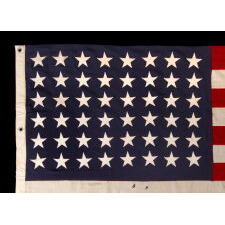 ANTIQUE AMERICAN FLAG WITH 48 STARS, A U.S. NAVY SMALL BOAT ENSIGN, MADE DURING WWII, IN DECEMBER OF 1943, AT MARE ISLAND, CALIFORNIA, HEADQUARTERS OF THE PACIFIC FLEET, SIGNED & DATED