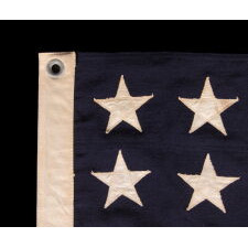 ANTIQUE AMERICAN FLAG WITH 48 STARS, A U.S. NAVY SMALL BOAT ENSIGN, MADE DURING WWII, IN DECEMBER OF 1943, AT MARE ISLAND, CALIFORNIA, HEADQUARTERS OF THE PACIFIC FLEET, SIGNED & DATED