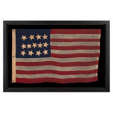ANTIQUE AMERICAN FLAG WITH A WHIMSICAL PRESENTATION OF 13 STARS IN THE 4-5-4 PATTERN, A VERY EARLY EXAMPLE, MADE circa 1835-1850’s, BOLDY GRAPHIC, ENTIRELY HAND-SEWN AND IN A TINY SCALE AMONG ITS COUNTERPARTS, PROBABLY A U.S. NAVY SMALL BOAT ENSIGN