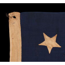 ANTIQUE AMERICAN FLAG WITH A WHIMSICAL PRESENTATION OF 13 STARS IN THE 4-5-4 PATTERN, A VERY EARLY EXAMPLE, MADE circa 1835-1850’s, BOLDY GRAPHIC, ENTIRELY HAND-SEWN AND IN A TINY SCALE AMONG ITS COUNTERPARTS, PROBABLY A U.S. NAVY SMALL BOAT ENSIGN