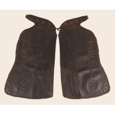 ANTIQUE, BATWING, LEATHER CHAPS WITH GREAT PATINA AND “TEXAS” SPELLED OUT IN THE STUDS, circa 1915-1930