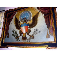 BOLD, EBONIZED CARVING OF AN AMERICAN EAGLE, EXPERTLY DEVELOPED & DRAMATICALLY POSED, AS IF EMERGING REVERENT ON A BED OF CLOUDS, circa 1785 – 1820