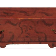 QUEEN ANNE PERIOD BLANKET CHEST, CONNECTICUT RIVER VALLEY, PROBABLY MASSACHUSETTS, WITH BLACK DECORATION ON A RED GROUND THAT INCLUDES TWO WHIMSICAL FACES, ca 1740-1760