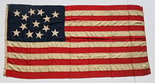 1876 CENTENNIAL ERA 13 STAR FLAG WITH 13 HAND-SEWN STARS IN AN ELONGATED FORM OF THE MEDALLION CONFIGURATION