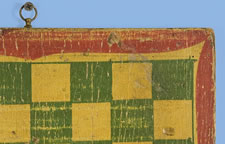 CHROME YELLOW, APPLE GREEN, AND SCARLET CHECKERBOARD WITH THE NAME OF THE MAKER PAINTED ON THE REVERSE