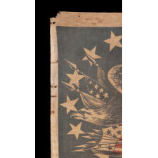 EXTRAORDINARILY RARE ANTIQUE AMERICAN FLAG WITH A THREE-COLOR CANTON THAT CONSISTS OF A TREMENDOUS, WARLIKE EAGLE, PERCHED ON A FEDERAL SHIELD, SET WITHIN A RING OF 14 STARS; MADE IN THE PERIOD BETWEEN THE MEXICAN AND CIVIL WARS (1846 – 1865) THIS IS THE ONLY KNOWN EXAMPLE IN THIS STYLE AND THE LARGEST OF ALL KNOWN RECORDED PARADE FLAGS WITH AN EAGLE AS THE PRIMARY IMAGE