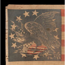 EXTRAORDINARILY RARE ANTIQUE AMERICAN FLAG WITH A THREE-COLOR CANTON THAT CONSISTS OF A TREMENDOUS, WARLIKE EAGLE, PERCHED ON A FEDERAL SHIELD, SET WITHIN A RING OF 14 STARS; MADE IN THE PERIOD BETWEEN THE MEXICAN AND CIVIL WARS (1846 – 1865) THIS IS THE ONLY KNOWN EXAMPLE IN THIS STYLE AND THE LARGEST OF ALL KNOWN RECORDED PARADE FLAGS WITH AN EAGLE AS THE PRIMARY IMAGE