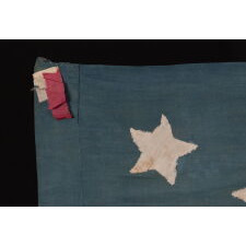 13 STAR ANTIQUE AMERICAN FLAG OF THE CIVIL WAR PERIOD (1861-1865), HOMEMADE AND ENTIRELY HAND-SEWN, WITH ITS CANTON RESTING ON THE WAR STRIPE, AND WITH 9 STRIPES TO REFLECT THE OMISSION OF NORTH & SOUTH CAROLINA, GEORGIA, AND VIRGINIA, THE 4 SLAVE STATES AMONG THE ORIGINAL 13 COLONIES THAT SECEDED FROM THE UNION