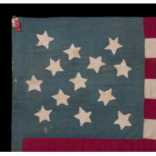 13 STAR ANTIQUE AMERICAN FLAG OF THE CIVIL WAR PERIOD (1861-1865), HOMEMADE AND ENTIRELY HAND-SEWN, WITH ITS CANTON RESTING ON THE WAR STRIPE, AND WITH 9 STRIPES TO REFLECT THE OMISSION OF NORTH & SOUTH CAROLINA, GEORGIA, AND VIRGINIA, THE 4 SLAVE STATES AMONG THE ORIGINAL 13 COLONIES THAT SECEDED FROM THE UNION