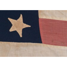 22 STAR ANTIQUE AMERICAN FLAG OF THE CIVIL WAR ERA; A SOUTHERN-EXCLUSIONARY COUNT ARRANGED IN A DOUBLE-WREATH MEDALLION CONFIGURATION; HOMEMADE OF WOOL AND COTTON; A RARE STAR COUNT IN ANY PERIOD; EXHIBITED AT THE MUSEUM OF THE AMERICAN REVOLUTION FROM JUNE – SEPTEMBER, 2021