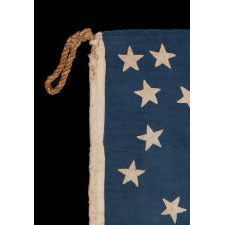 EXTRAORDINARY 34 STAR ANTIQUE AMERICAN FLAG WITH AN ACCORDION OR HOURGLASS MEDALLION CONFIGURATION THAT SURROUNDS A PENTAGON OF STARS IN THE CENTER; MADE OF FINE SILK AND ENTIRELY HAND-SEWN; MADE DURING THE OPENING YEARS OF THE CIVIL WAR (1861-63), IN A TINY SIZE AMONG ITS COUNTERPARTS OF THE PERIOD; REFLECTS THE ADDITION OF KANSAS AS THE 34TH STATE