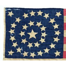 34 STARS ARRANGED IN A BEAUTIFUL RENDITION OF THE MEDALLION CONFIGURATION WITH OFFSET WREATHS AND A LARGE CENTER STAR, MADE DURING THE OPENING YEARS OF THE CIVIL WAR, 1861-1863, AND ENTIRELY HAND-SEWN, REFLECTS KANSAS STATEHOOD