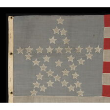 36 STAR ANTIQUE AMERICAN FLAG WITH ITS STARS ARRANGED IN THE "GREAT STAR" PATTERN, ON A DUSTY BLUE CANTON, AND THE FLY END OF THE LAST STRIPE SOUVENIRED; MADE circa 1864-67, CIVIL WAR ERA; LIKELY BELONGING TO CAPTAIN H.R. JENNINGS OF THE 21ST CONNECTICUT VOLUNTEER INFANTRY, KILLED AT PETERSBURG