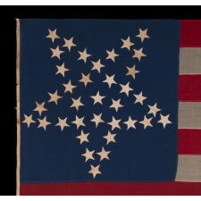 36 STARS IN THE "GREAT STAR" OR "GREAT LUMINARY" PATTERN, ON A MERINO WOOL FLAG OF THE CIVIL WAR ERA WITH BEAUTIFUL SCARLET AND ROYAL BLUE COLOR AND WITH ITS CANTON RESTING ON THE "WAR STRIPE," REFLECTS NEVADA STATEHOOD, 1864-67