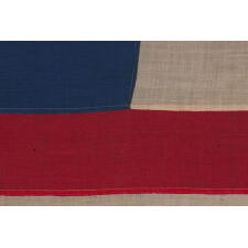 36 STARS IN THE "GREAT STAR" OR "GREAT LUMINARY" PATTERN, ON A MERINO WOOL FLAG OF THE CIVIL WAR ERA WITH BEAUTIFUL SCARLET AND ROYAL BLUE COLOR AND WITH ITS CANTON RESTING ON THE "WAR STRIPE," REFLECTS NEVADA STATEHOOD, 1864-67