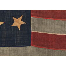 ANTIQUE AMERICAN FLAG WITH 13 HAND-SEWN STARS IN AN EXTREMELY RARE LINEAL CONFIGURATION OF 5-3-5, PROBABLY MADE WITH THE INTENT OF USE BY LOCAL MILITIA OR PRIVATE OUTFITTING OF A VOLUNTEER COMPANY, CIVIL WAR PERIOD, 1861-1865; EXHIBITED AT THE MUSEUM OF THE AMERICAN REVOLUTION FROM JUNE – JULY, 2019