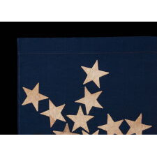 ANTIQUE AMERICAN FLAG OF THE CIVIL WAR PERIOD, WITH 13 STARS IN A "PINWHEEL GREAT STAR," A MASTERPIECE OF EARLY AMERICAN FLAG-MAKING