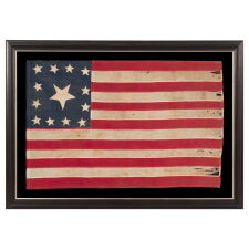 EXTRAORDINARY CIVIL WAR ERA FLAG, WITH 13 HAND-SEWN STARS ARRANGED IN A VARIANT OF WHAT IS KNOWN AS THE TRUMBULL PATTERN, FEATURING A HUGE, UPSIDE-DOWN CENTER STAR, AND THE EXTREMELY RARE TRAIT OF HAVING A DIFFERENT STAR COUNT ON THE REVERSE, WHICH DISPLAYS 36 STARS; HANDED DOWN THROUGH THE FAMILY OF GROVE H. "STOWE" DUDLEY OF THE 100th INDIANA, circa 1864-67