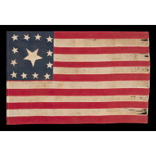 EXTRAORDINARY CIVIL WAR ERA FLAG, WITH 13 HAND-SEWN STARS ARRANGED IN A VARIANT OF WHAT IS KNOWN AS THE TRUMBULL PATTERN, FEATURING A HUGE, UPSIDE-DOWN CENTER STAR, AND THE EXTREMELY RARE TRAIT OF HAVING A DIFFERENT STAR COUNT ON THE REVERSE, WHICH DISPLAYS 36 STARS; HANDED DOWN THROUGH THE FAMILY OF GROVE H. "STOWE" DUDLEY OF THE 100th INDIANA, circa 1864-67