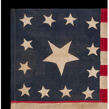 EXTRAORDINARY CIVIL WAR ERA FLAG, WITH 13 HAND-SEWN STARS ARRANGED IN A VARIANT OF WHAT IS KNOWN AS THE TRUMBULL PATTERN, FEATURING A HUGE, UPSIDE-DOWN CENTER STAR, AND THE EXTREMELY RARE TRAIT OF HAVING A DIFFERENT STAR COUNT ON THE REVERSE, WHICH DISPLAYS 36 STARS; HANDED DOWN THROUGH THE FAMILY OF GROVE H. "STOWE" DUDLEY OF THE 100th INDIANA, circa 1864-67