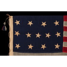 13 STARS IN THE 4-5-4 PATTERN ON AN ENTIRELY HAND-SEWN FLAG OF THE CIVIL WAR PERIOD, OR JUST PRIOR, circa 1854-1864, WITH HEMP ROPE AND A SINGLE TASSEL; PROBABLY A U.S. NAVY SMALL BOAT ENSIGN; SIGNED “JENNIE B. SEAVER,” NEWTON, MASSACHUSETTS