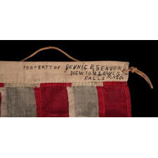 13 STARS IN THE 4-5-4 PATTERN ON AN ENTIRELY HAND-SEWN FLAG OF THE CIVIL WAR PERIOD, OR JUST PRIOR, circa 1854-1864, WITH HEMP ROPE AND A SINGLE TASSEL; PROBABLY A U.S. NAVY SMALL BOAT ENSIGN; SIGNED “JENNIE B. SEAVER,” NEWTON, MASSACHUSETTS
