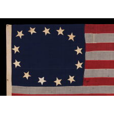 13 STARS IN A CRUDE SINGLE WREATH, REMINISCENT OF THE BETSY ROSS PATTERN, THOUGH RENDERED AS MORE OF AN OVAL; ON AN ANTIQUE AMERICAN FLAG MADE & SIGNED BY THE SHOP OF WILLIAM SCHEIBLE, 49 S. 3RD STREET, PHILADELPHIA, APPROX. TWO BLOCKS FROM INDEPENDENCE HALL AND THE SAME FROM THE BETSY ROSS HOUSE; A CIVIL WAR ERA FLAG, WITH AN EXTREMELY RARE & DESIRABLE CONFIGURATION OF STARS FOR THIS PERIOD, CIRCA 1861-65