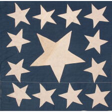 13 STARS IN THE RARE AND VERY DESIRABLE TRUMBULL PATTERN, WITH AN UNUSUALLY ENORMOUS CENTER STAR, ON A HOMEMADE, ANTIQUE AMERICAN FLAG PRODUCED SOMETIME BETWEEN THE CIVIL WAR (1861-1865) & THE 1876 CENTENNIAL OF AMERICAN INDEPENDENCE; THIS STAR CONFIGURATION NAMED FOR ARTIST JOHN TRUMBULL, WHO BRIEFLY SERVED AS GEORGE WASHINGTON’S AIDE-DE-CAMP (1776), BEFORE TRAVELING TO BRITAIN TO TRAIN UNDER WORLD-RENOWNED AMERICAN PAINTER, BENJAMIN WEST, THEN RETURNING TO THE STATES, WHERE HE AFTERWARDS FEA