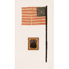 29 STARS IN A SPECTACULAR CROSS OR STARBURST MEDALLION, ONE OF JUST TWO KNOWN EXAMPLES IN THIS STYLE, PRE-CIVIL WAR, 1846-48, MEXICAN WAR PERIOD, REFLECTS THE ADDITION OF IOWA AS THE 29TH STATE; FORMERLY AMONG THE POSSESSIONS OF CORPORAL NATHANIEL POWERS, COLOR BEARER IN THE 10TH MASSACHUSETTS VOLUNTEERS, WHO LOST HIS ARM AT THE BATTLE OF FAIR OAKS, VIRGINIA IN 1862; THE FLAG-ITS STAFF WRAPPED IN BLACK CREPE—IS REPORTED TO HAVE BEEN DISTRIBUTED TO MOURNERS IN THE STREETS OF WASHINGTON, DC, ON