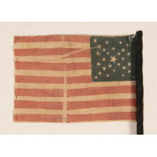 29 STARS IN A SPECTACULAR CROSS OR STARBURST MEDALLION, ONE OF JUST TWO KNOWN EXAMPLES IN THIS STYLE, PRE-CIVIL WAR, 1846-48, MEXICAN WAR PERIOD, REFLECTS THE ADDITION OF IOWA AS THE 29TH STATE; FORMERLY AMONG THE POSSESSIONS OF CORPORAL NATHANIEL POWERS, COLOR BEARER IN THE 10TH MASSACHUSETTS VOLUNTEERS, WHO LOST HIS ARM AT THE BATTLE OF FAIR OAKS, VIRGINIA IN 1862; THE FLAG-ITS STAFF WRAPPED IN BLACK CREPE—IS REPORTED TO HAVE BEEN DISTRIBUTED TO MOURNERS IN THE STREETS OF WASHINGTON, DC, ON