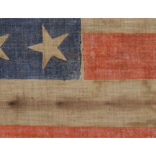 34 STARS ON AN ANTIQUE AMERICAN PARADE FLAG OF THE CIVIL WAR PERIOD, LARGE AMONG ITS COUNTERPARTS, WITH EXTENSIVE AND ENDEARING WEAR FROM OBVIOUS LONG-TERM USE; REFLECTS THE ERA WHEN KANSAS WAS THE MOST RECENT STATE TO JOIN THE UNION, 1861-63