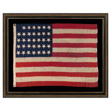 34 UPSIDE-DOWN, HAND-SEWN STARS IN A NOTCHED CONFIGURATION, ON AN ANTIQUE AMERICAN FLAG OF THE CIVIL WAR PERIOD, WITH A SQUARISH PROFILE AND IN AN EXTREMELY SMALL SCALE AMONG ITS COUNTERPARTS; FOUND IN PENNSYLVANIA & RELATED TO ANOTHER FLAG FOUND IN THE RAFTERS OF A BARN IN PERRY COUNTY; REFLECTS THE ADDITION OF KANSAS AS THE 34TH STATE, circa 1861-1863