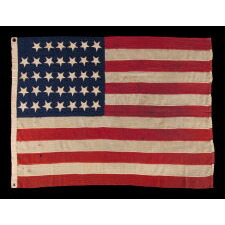 34 UPSIDE-DOWN, HAND-SEWN STARS IN A NOTCHED CONFIGURATION, ON AN ANTIQUE AMERICAN FLAG OF THE CIVIL WAR PERIOD, WITH A SQUARISH PROFILE AND IN AN EXTREMELY SMALL SCALE AMONG ITS COUNTERPARTS; FOUND IN PENNSYLVANIA & RELATED TO ANOTHER FLAG FOUND IN THE RAFTERS OF A BARN IN PERRY COUNTY; REFLECTS THE ADDITION OF KANSAS AS THE 34TH STATE, circa 1861-1863