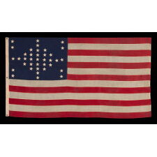 37 STARS IN A VERY RARE DIAMOND CONFIGURATION, WITH PILLARS OF STARS ON EITHER SIDE, NEARLY IDENTICAL TO A LARGER EXAMPLE PRESENTED BY CIVIL WAR GENERAL BENJAMIN BUTLER TO PRESIDENT LINCOLN AS THE FIRST AMERICAN FLAG EVER CONSTRUCTED OF ENTIRELY AMERICAN-MADE MATERIALS, JUST 3 DAYS PRIOR TO HIS 1865 ASSASSINATION; THIS STAR COUNT ANTICIPATORY TO THE FUTURE ADDITION OF NEBRASKA