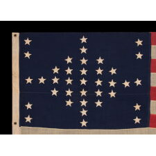 37 STARS IN A VERY RARE DIAMOND CONFIGURATION, WITH PILLARS OF STARS ON EITHER SIDE, NEARLY IDENTICAL TO A LARGER EXAMPLE PRESENTED BY CIVIL WAR GENERAL BENJAMIN BUTLER TO PRESIDENT LINCOLN AS THE FIRST AMERICAN FLAG EVER CONSTRUCTED OF ENTIRELY AMERICAN-MADE MATERIALS, JUST 3 DAYS PRIOR TO HIS 1865 ASSASSINATION; THIS STAR COUNT ANTICIPATORY TO THE FUTURE ADDITION OF NEBRASKA