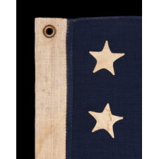 37 STARS IN A VERY RARE DIAMOND CONFIGURATION, WITH PILLARS OF STARS ON EITHER SIDE, NEARLY IDENTICAL TO A LARGER EXAMPLE PRESENTED BY CIVIL WAR GENERAL BENJAMIN BUTLER TO PRESIDENT LINCOLN AS THE FIRST AMERICAN FLAG EVER CONSTRUCTED OF ENTIRELY AMERICAN-MADE MATERIALS, JUST 3 DAYS PRIOR TO HIS 1865 ASSASSINATION; THIS STAR COUNT ANTICIPATORY TO THE FUTURE ADDITION OF NEBRASKA