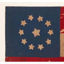 CONFEDERATE FIRST NATIONAL PATTERN FLAG (a.k.a., STARS & BARS) WITH 11 STARS, IN A TINY SIZE AMONG THOSE WITH PIECED AND SEWN CONSTRUCTION, A HOMEMADE, CIVIL WAR-PERIOD FLAG, FOUND IN GREATER BALTIMORE, LIKELY DISPLAYED FROM A PODIUM, PARADE FLOAT, CARRIAGE, OR STOREFRONT, circa MAY – NOV., 1861