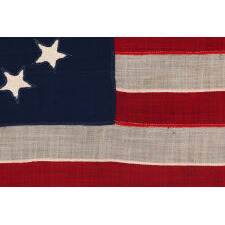 ENTIRELY HAND-SEWN ANTIQUE AMERICAN FLAG OF THE CIVIL WAR PERIOD, WITH 13 SINGLE-APPLIQUED STARS IN A BEAUTIFUL, OVAL ARRANGEMENT OF WHAT IS KNOWN AS THE 3RD MARYLAND PATTERN, MADE SOMETIME BETWEEN THE 1850’s AND THE CIVIL WAR (1861-65)