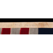 ENTIRELY HAND-SEWN ANTIQUE AMERICAN FLAG OF THE CIVIL WAR PERIOD, WITH 13 SINGLE-APPLIQUED STARS IN A BEAUTIFUL, OVAL ARRANGEMENT OF WHAT IS KNOWN AS THE 3RD MARYLAND PATTERN, MADE SOMETIME BETWEEN THE 1850’s AND THE CIVIL WAR (1861-65)