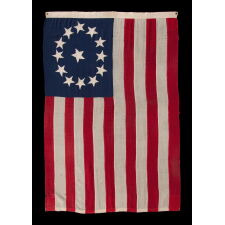 ENTIRELY HAND-SEWN ANTIQUE AMERICAN FLAG OF THE CIVIL WAR PERIOD, WITH 13 SINGLE-APPLIQUED STARS IN A BEAUTIFUL, OVAL ARRANGEMENT OF WHAT IS KNOWN AS THE 3RD MARYLAND PATTERN, MADE SOMETIME BETWEEN THE 1850’s AND THE CIVIL WAR (1861-65)